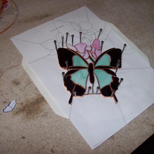 Travail en cours sur un vitrail tiffany représentant un papillon